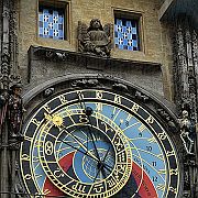 The Orloj is mounted on the southern wall of Old Town Hall. The clock mechanism has three main components – the astronomical dial, representing the position of the Sun and Moon in the sky; statues of various Catholic saints stand on either side of the clock; "The Walk of the Apostles", an hourly show of moving Apostle figures and a figure of a skeleton that represents Death, striking the time; and a calendar dial with medallions representing the months.